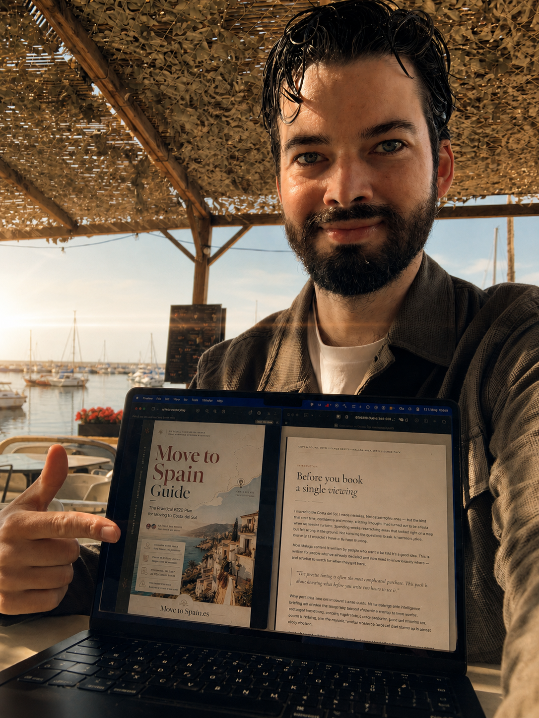 Duncan holding the Move to Spain guide at a marina in Andalusia